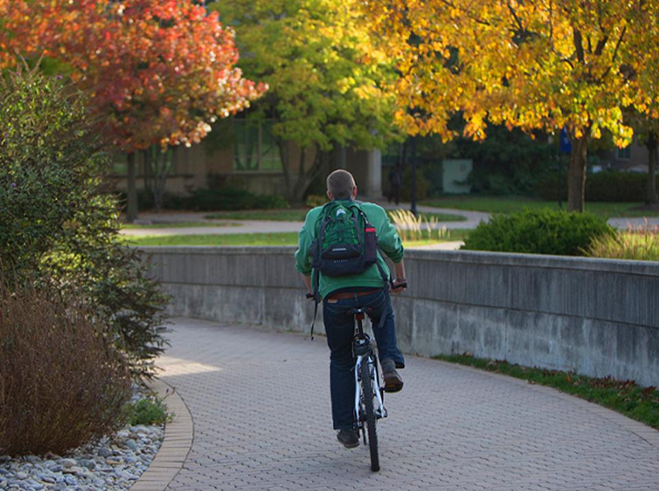 Student biking on campus