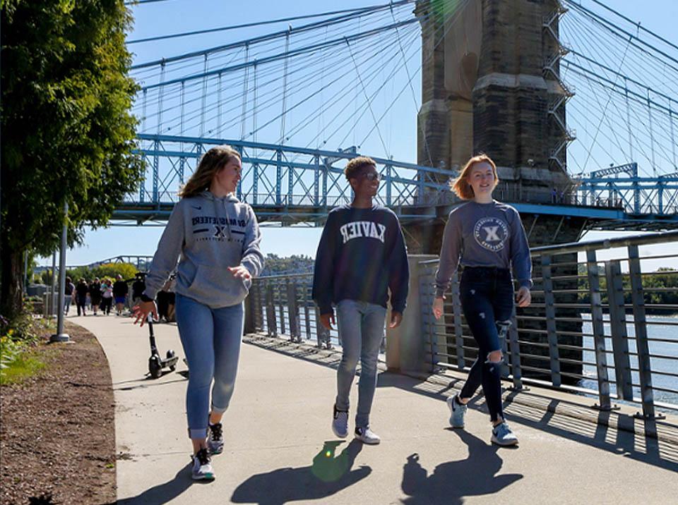 Three Xavier students walking in downtown Cincinnati
