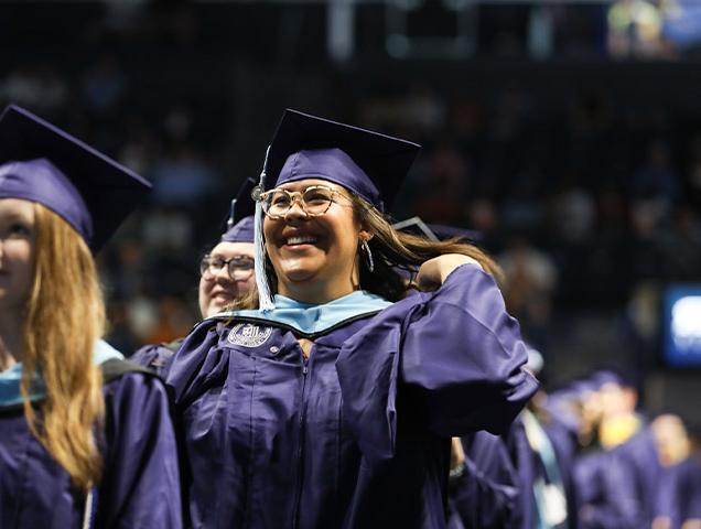 A grad student celebrating at graduation 